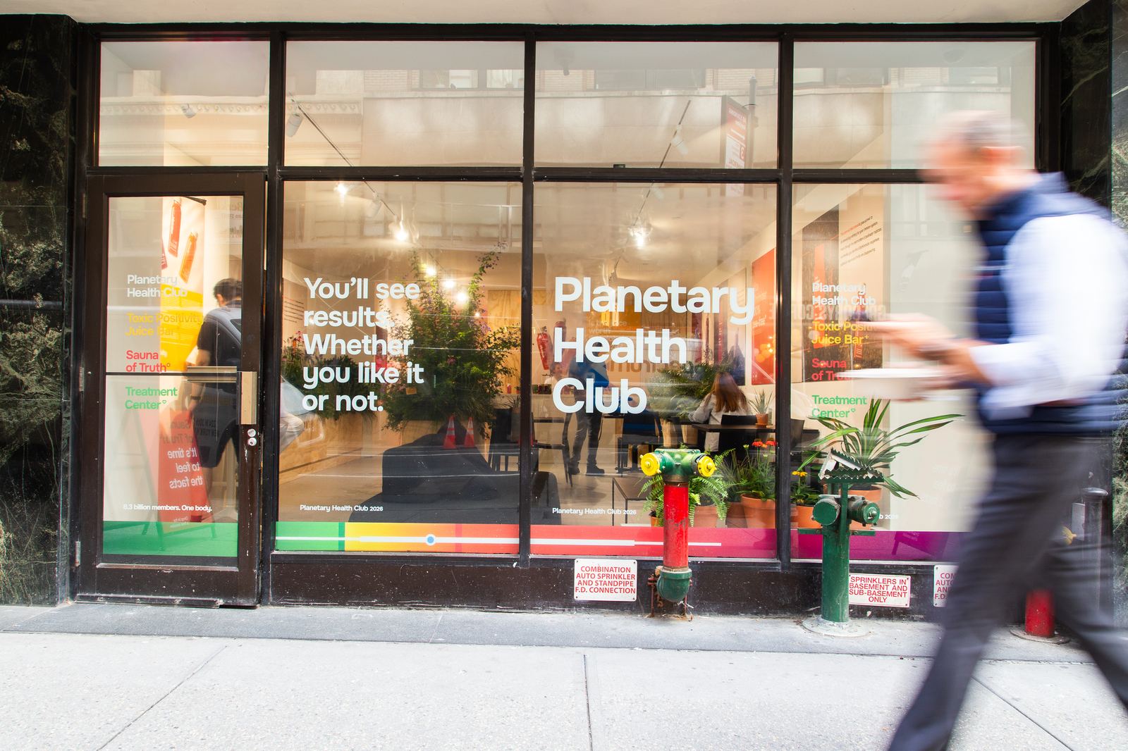 The Planetary Health Club storefront, with window lettering reading You'll see results. Whether you like it or not.