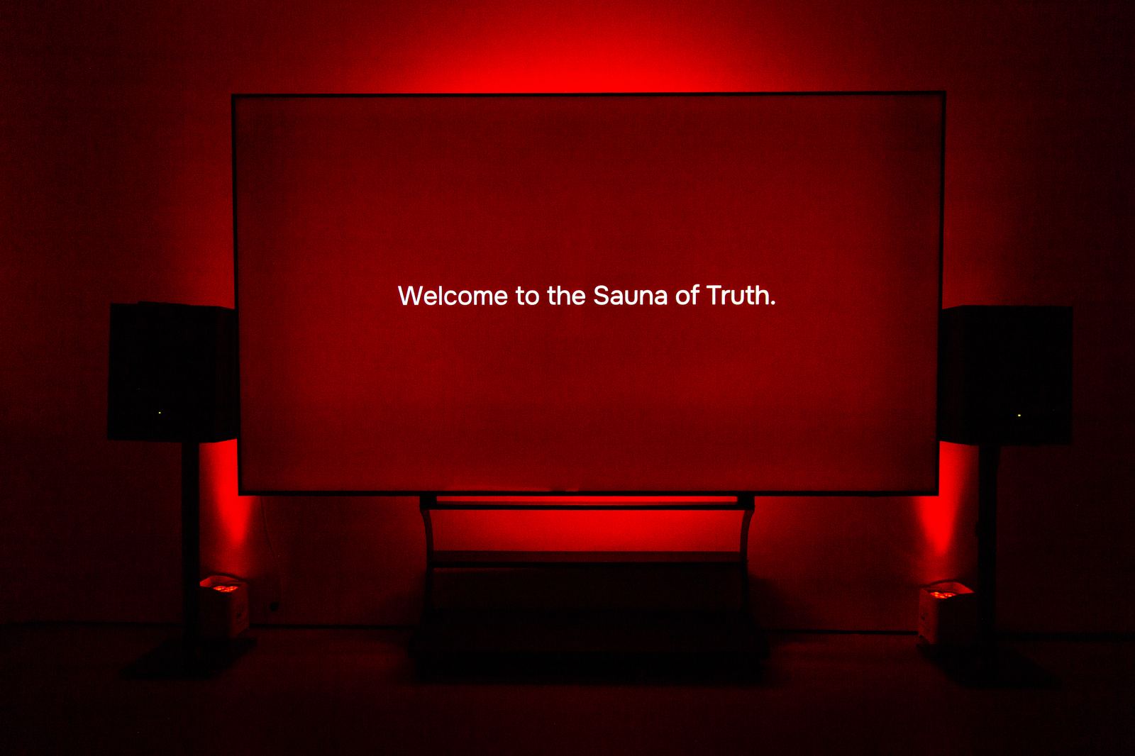 A red-lit screen reading Welcome to the Sauna of Truth